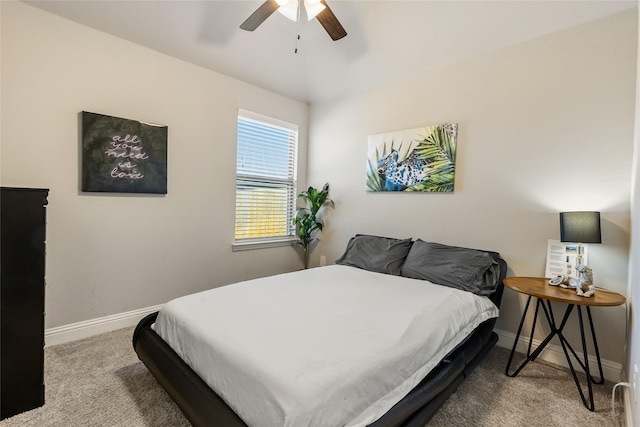 carpeted bedroom featuring a ceiling fan and baseboards