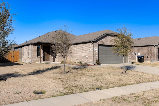 ranch-style house featuring a shingled roof, concrete driveway, brick siding, and an attached garage