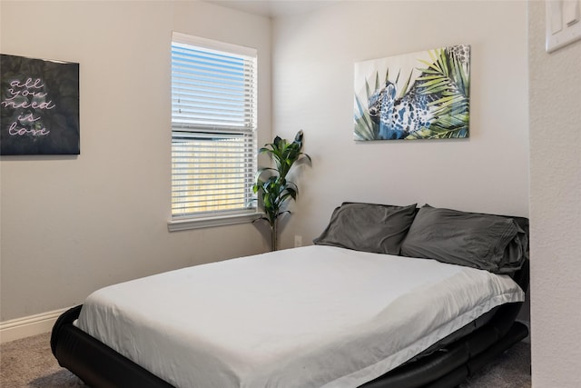 bedroom with carpet floors and baseboards