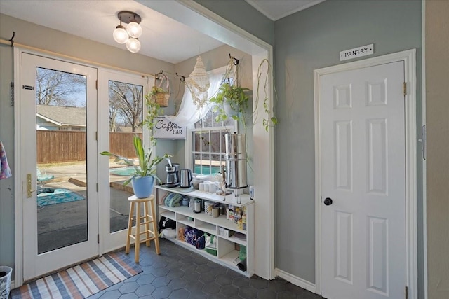 doorway to outside with a wealth of natural light and tile patterned floors