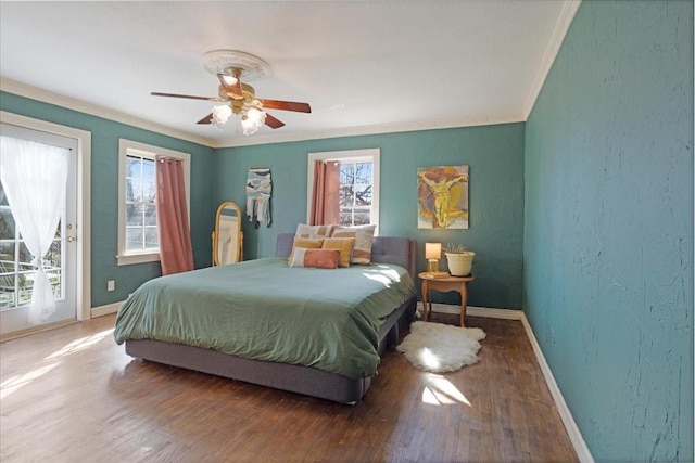 bedroom with baseboards, crown molding, and wood finished floors