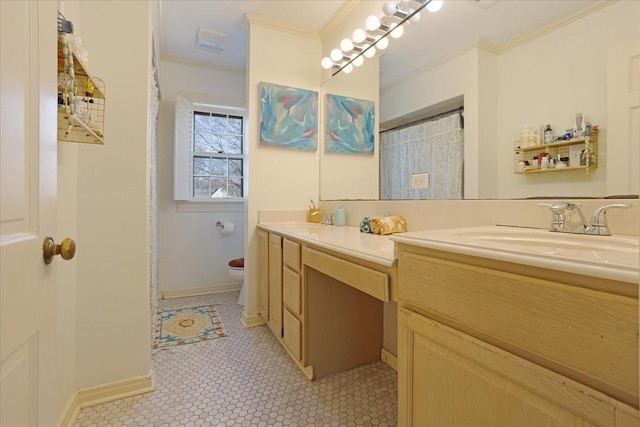 bathroom with baseboards, crown molding, vanity, and toilet