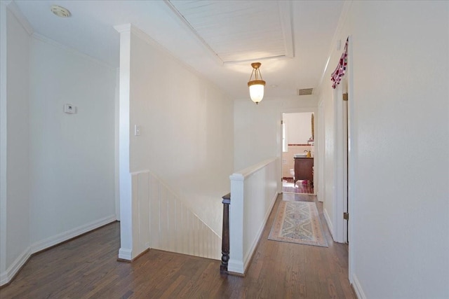 corridor with crown molding, visible vents, an upstairs landing, wood finished floors, and baseboards