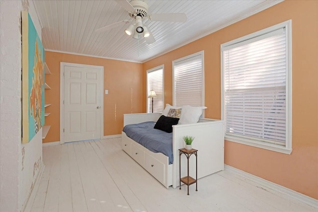 bedroom featuring baseboards, wooden ceiling, ceiling fan, wood finished floors, and crown molding