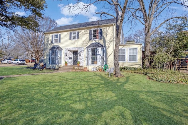 colonial-style house with a front lawn