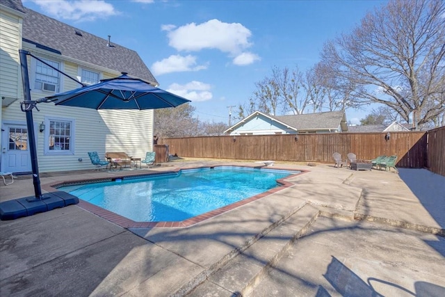 view of pool with a diving board, a patio area, a fenced backyard, and a fenced in pool