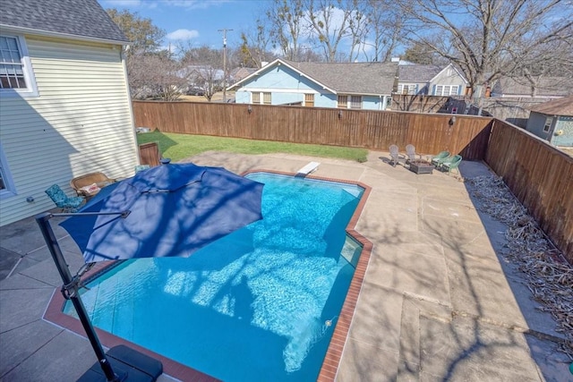 view of swimming pool with a patio area, a fenced backyard, a diving board, and a fenced in pool