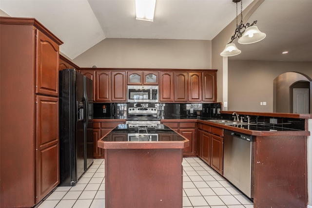 kitchen featuring lofted ceiling, stainless steel appliances, a peninsula, and light tile patterned flooring