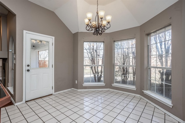 unfurnished dining area featuring a healthy amount of sunlight, vaulted ceiling, a notable chandelier, and light tile patterned flooring