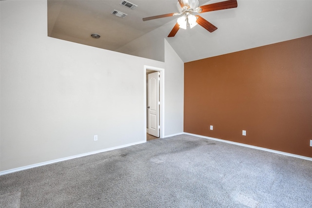 spare room with carpet floors, visible vents, a ceiling fan, and lofted ceiling