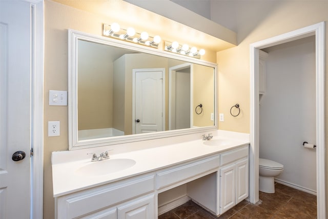 full bath with double vanity, toilet, a sink, and tile patterned floors