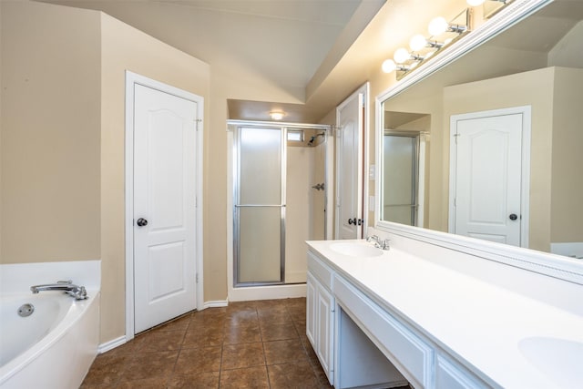 full bathroom featuring double vanity, tile patterned floors, a garden tub, a shower stall, and a sink