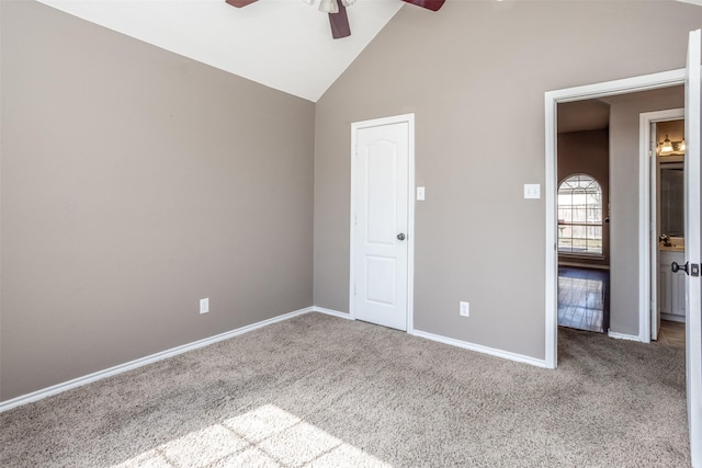 unfurnished bedroom with high vaulted ceiling, carpet, baseboards, and a ceiling fan