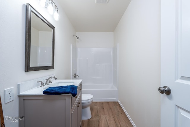 full bath featuring shower / bath combination, visible vents, toilet, wood finished floors, and vanity