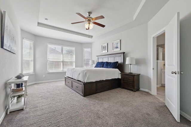 bedroom with baseboards, a raised ceiling, carpet floors, and ceiling fan