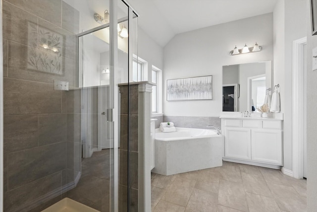 full bath with a shower stall, tile patterned flooring, a bath, vanity, and vaulted ceiling