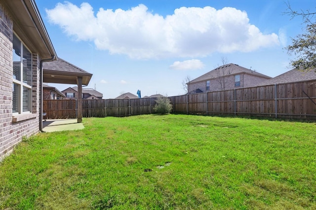 view of yard with a fenced backyard