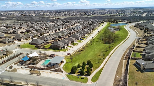 birds eye view of property with a residential view and a water view