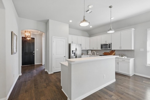 kitchen featuring white cabinetry, arched walkways, visible vents, and appliances with stainless steel finishes