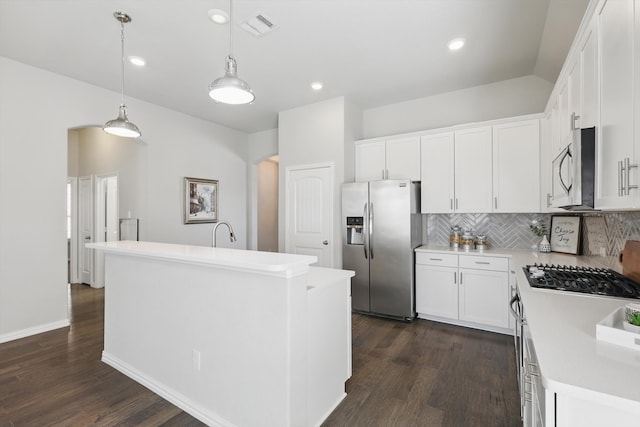 kitchen with visible vents, backsplash, stainless steel appliances, and light countertops