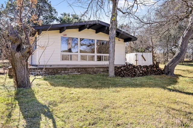 view of side of property with a lawn