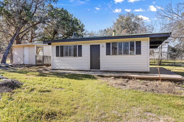 back of property featuring a yard