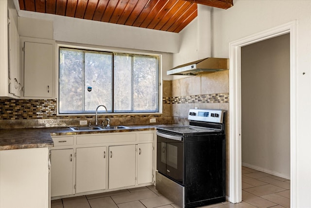 kitchen with dark countertops, wood ceiling, light tile patterned flooring, a sink, and range with electric cooktop