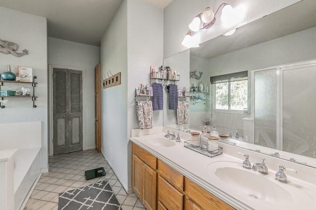 full bath featuring a stall shower, a garden tub, a sink, and tile patterned floors