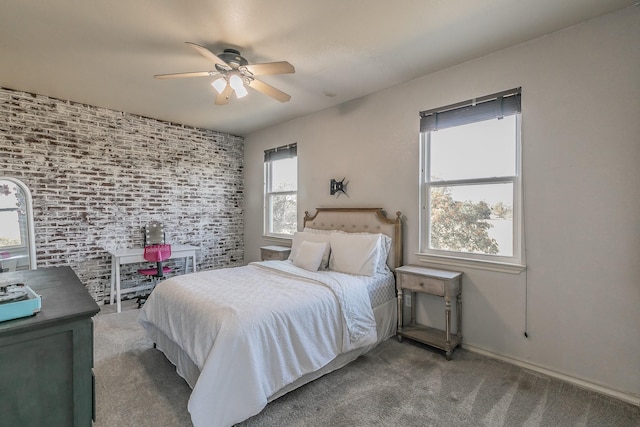 carpeted bedroom featuring brick wall and a ceiling fan