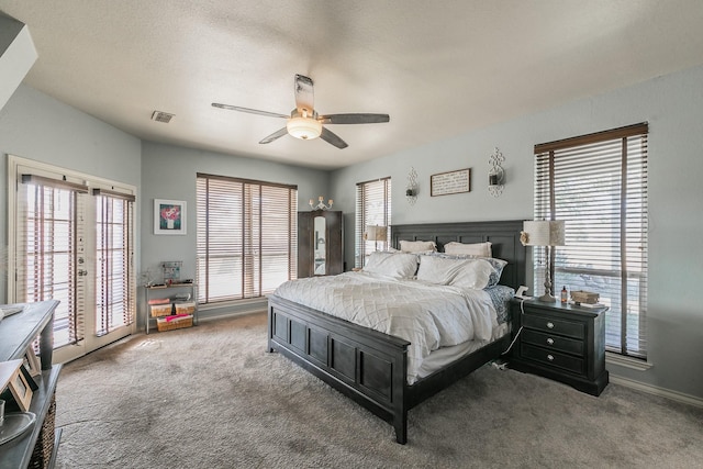 bedroom featuring access to outside, visible vents, carpet flooring, and multiple windows