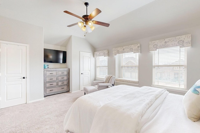 bedroom with a ceiling fan, carpet, lofted ceiling, and baseboards