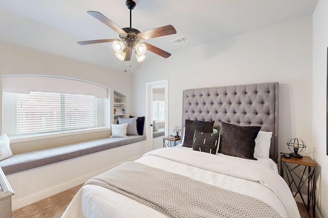 carpeted bedroom with lofted ceiling, visible vents, ceiling fan, and baseboards