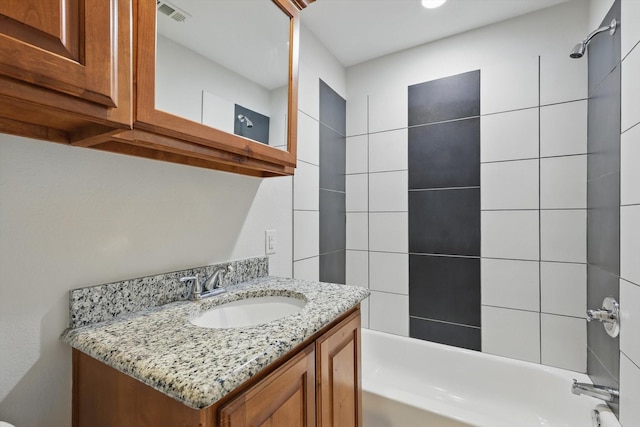 bathroom featuring  shower combination, vanity, and visible vents