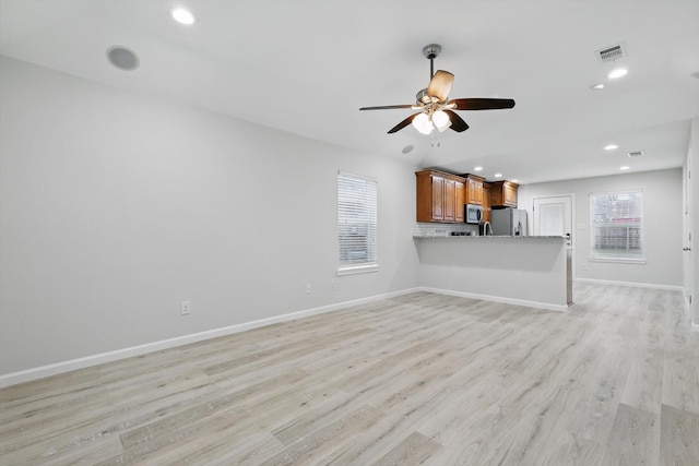 unfurnished living room featuring light wood finished floors, recessed lighting, visible vents, ceiling fan, and baseboards