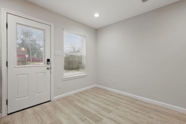 entryway featuring light wood-type flooring, baseboards, and recessed lighting