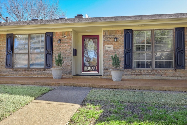 doorway to property with brick siding