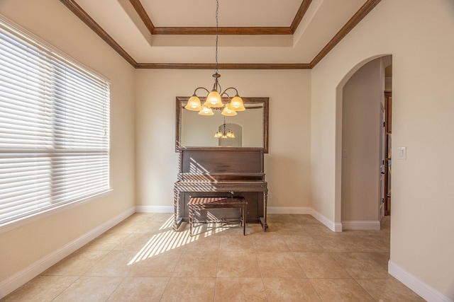 sitting room with arched walkways, plenty of natural light, a raised ceiling, and a notable chandelier