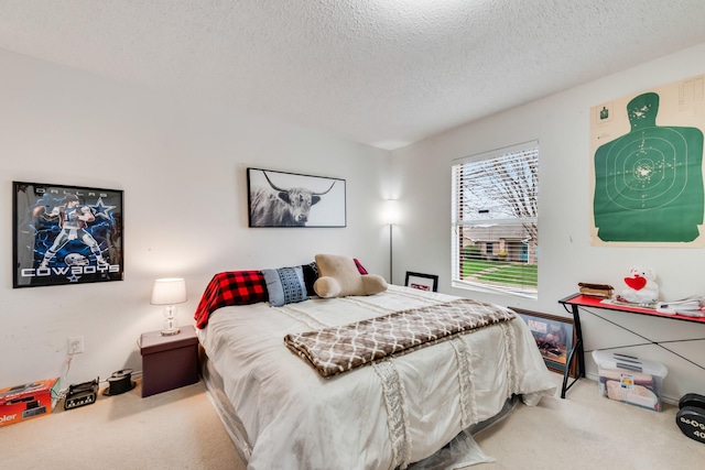 bedroom featuring carpet floors and a textured ceiling