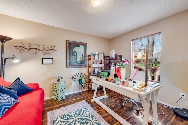 office area with a textured ceiling, wood finished floors, and baseboards