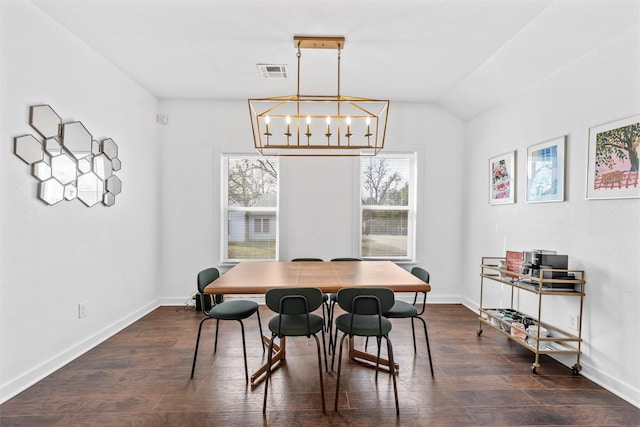 dining area featuring baseboards, visible vents, dark wood-style floors, vaulted ceiling, and a chandelier