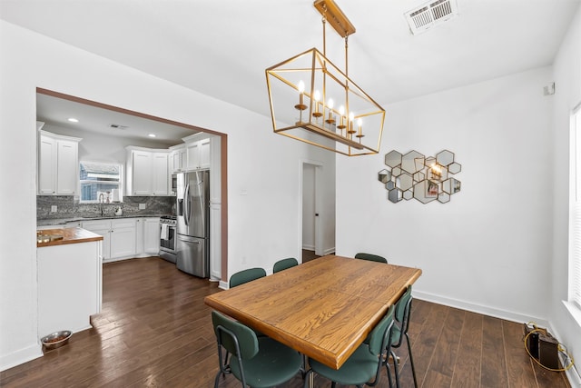 dining area with recessed lighting, dark wood-style flooring, visible vents, and baseboards