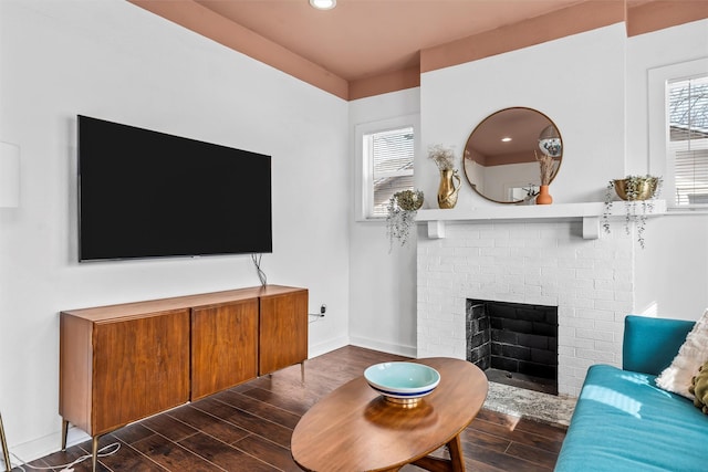living area with recessed lighting, a brick fireplace, wood finished floors, and baseboards
