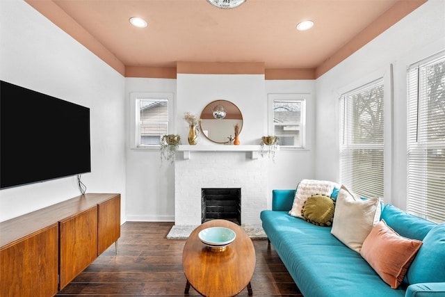living room featuring plenty of natural light, a fireplace, dark wood finished floors, and recessed lighting