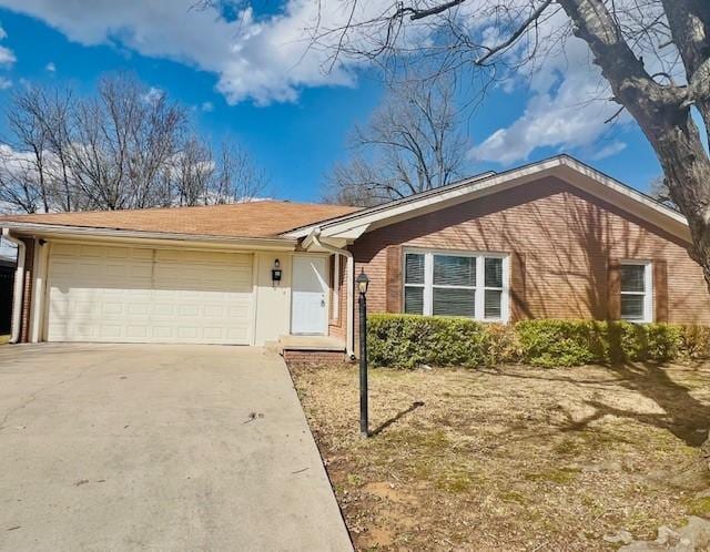 ranch-style home with brick siding, driveway, and an attached garage