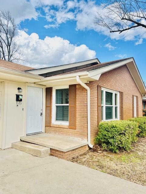 property entrance with brick siding