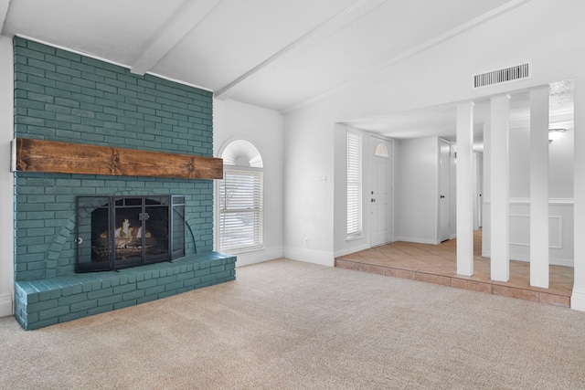 unfurnished living room featuring lofted ceiling with beams, carpet flooring, visible vents, baseboards, and a brick fireplace