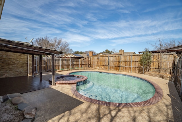 view of swimming pool with a patio area, a fenced backyard, and a pool with connected hot tub