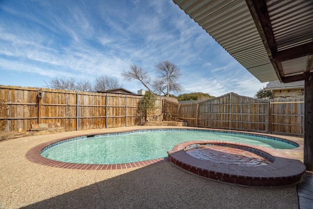 view of swimming pool with a fenced backyard and a pool with connected hot tub