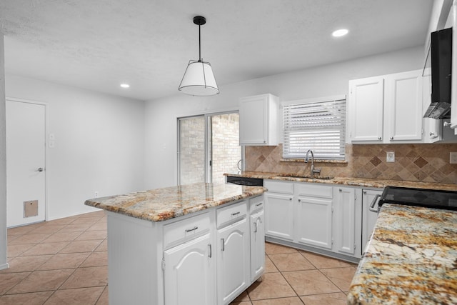 kitchen featuring a center island, light tile patterned floors, backsplash, white cabinets, and a sink