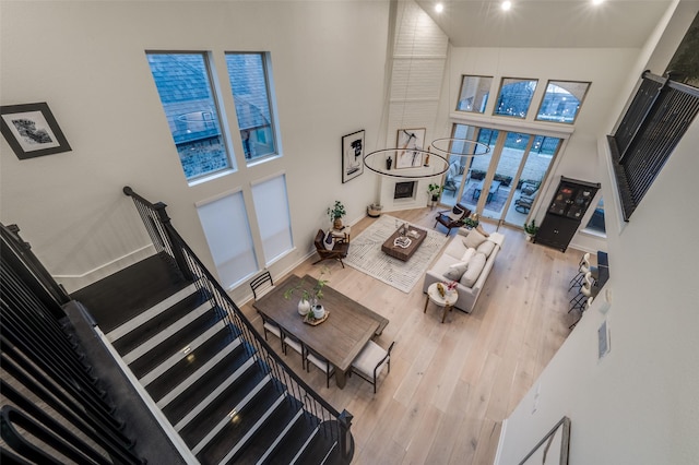 living room with a high ceiling, wood finished floors, and baseboards